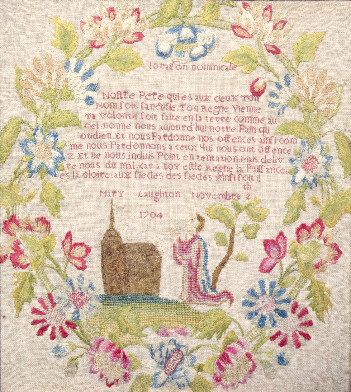 Sampleri, jossa on ranskankielinen Lords Prayer -rukous polvistuvan hahmon yläpuolella, työstö Mary Laughton, 1704 (silkkityö) Mary Laughton, 1704 tekijältä Unknown