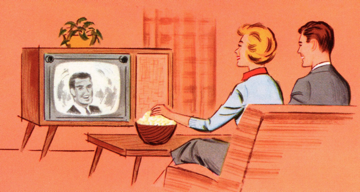 Pariskunta katsomassa retro-televisiota heidän luolassaan tekijältä American School