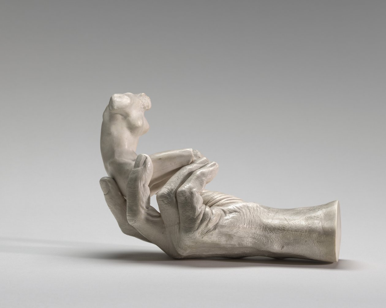 Rodinin käsi naishahmolla tekijältä Auguste Rodin