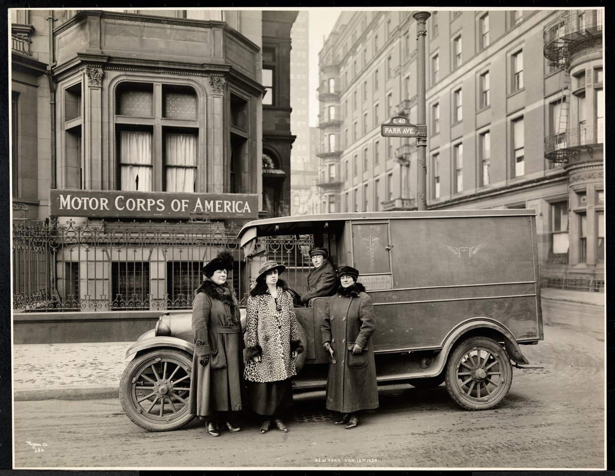 Neljä Motor Corps of Americain naista seisomassa ambulanssin edessä (yksi nainen kuljettajan istuimella) Park Avenuella osoitteessa 40th Street Motor Corps of America -rakennuksen edessä, New York, 1920 (s tekijältä Byron Company