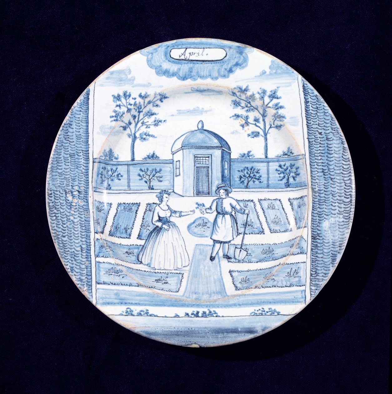 Delftware-levy, joka kuvaa huhtikuuta (tinalasitettu keramiikka) tekijältä Dutch School