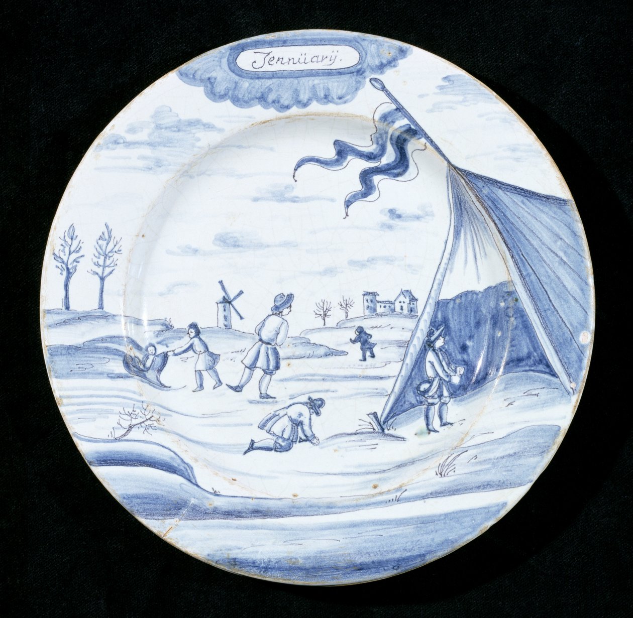 Delftware-lautanen, joka kuvaa tammikuuta (tinalasitettu keramiikka) tekijältä Dutch School