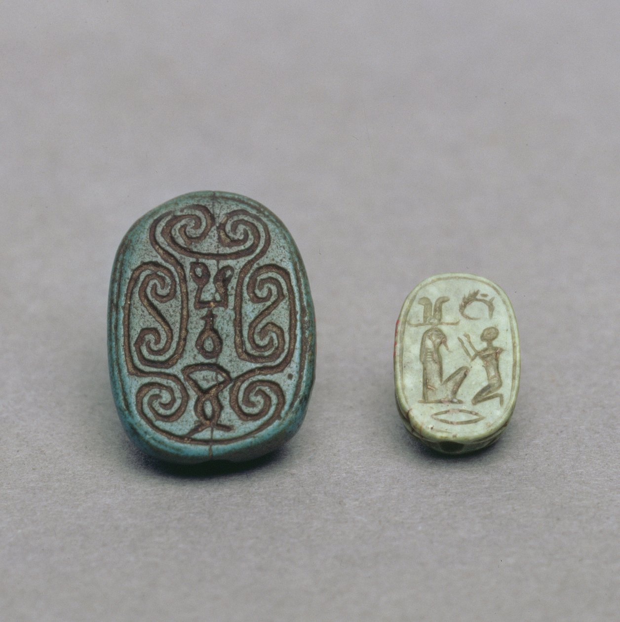 (L-R) Egyptiläinen fatiikki skarabeusamuletti, toinen välikausi, 13.-17. dynastia, noin 1650 eKr.; vihreä maasälpä skarabeusamuletti, myöhäiskausi, 26. dynastia, noin 600 eKr. tekijältä Egyptian