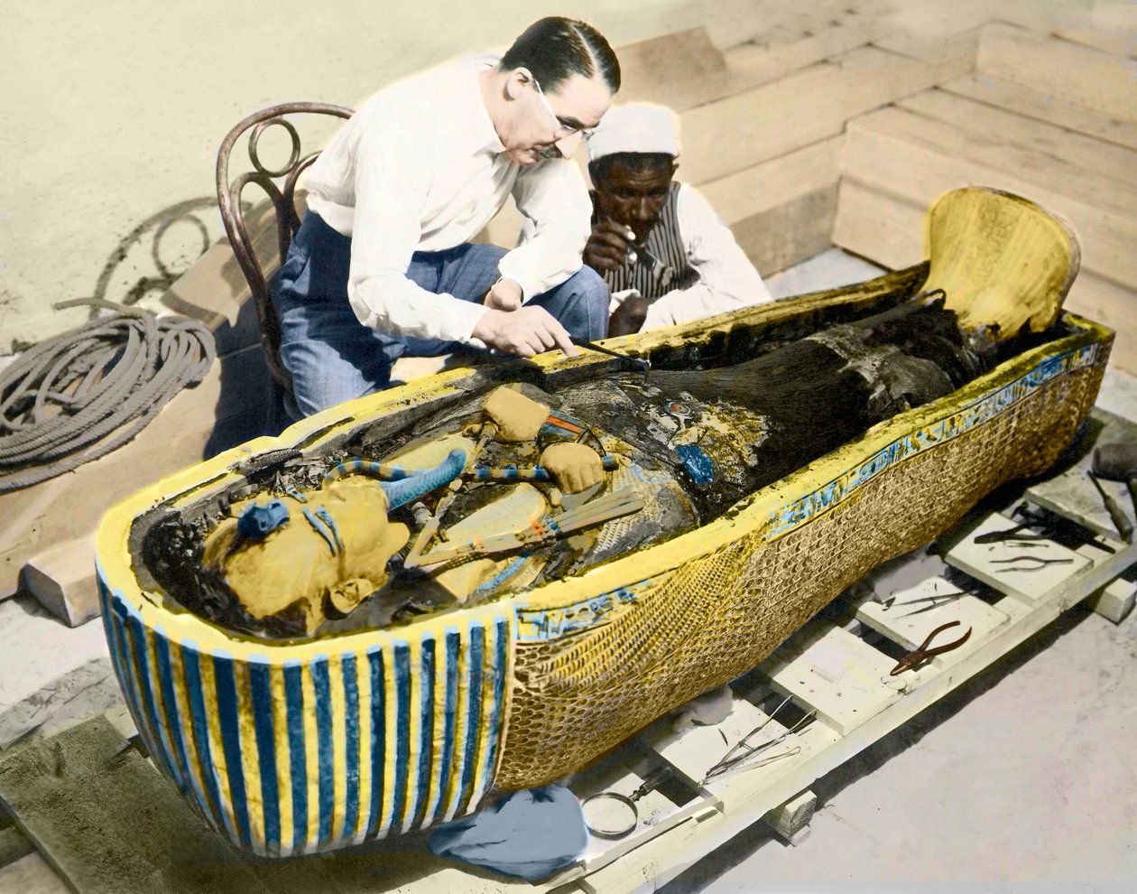 Egypti-1922: Englantilainen arkeologi Howard Carter (1873-1939) ja egyptiläinen avustaja tutkimassa kuningas Tutankhamonin sarkofagia. tekijältä English Photographer
