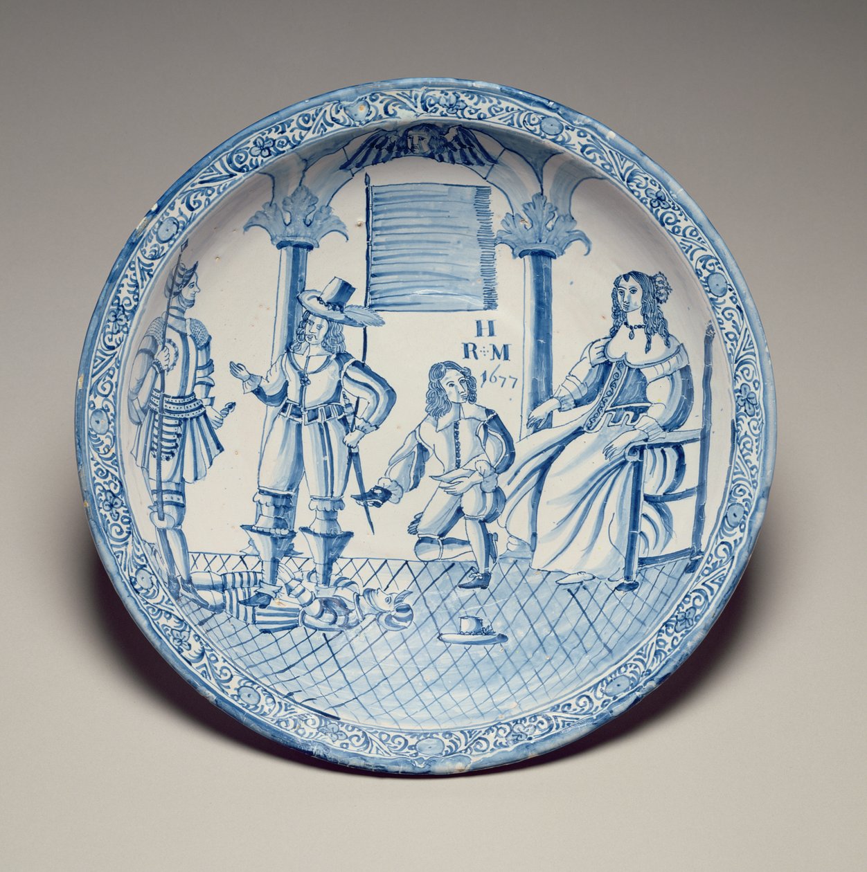 Astia, jossa kuningatar Katariina istuu ja polvistuvan Cavalierin asettama kenkä, 1677 (tinalasitettu keramiikka) tekijältä English School