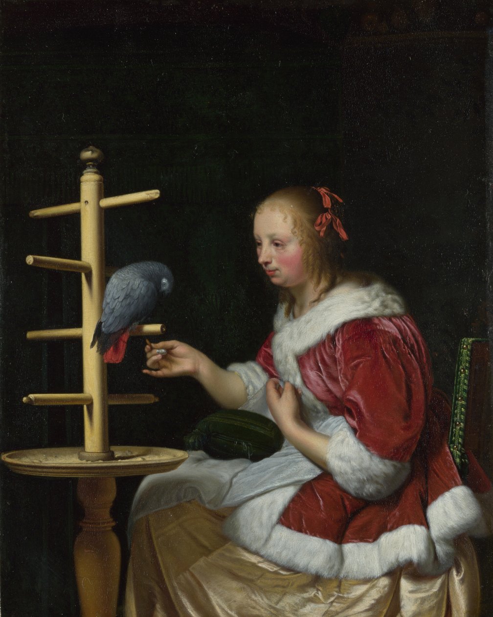 Nainen punaisessa takissa ruokkimassa papukaijaa, n. 1663 tekijältä Frans van Mieris the Elder