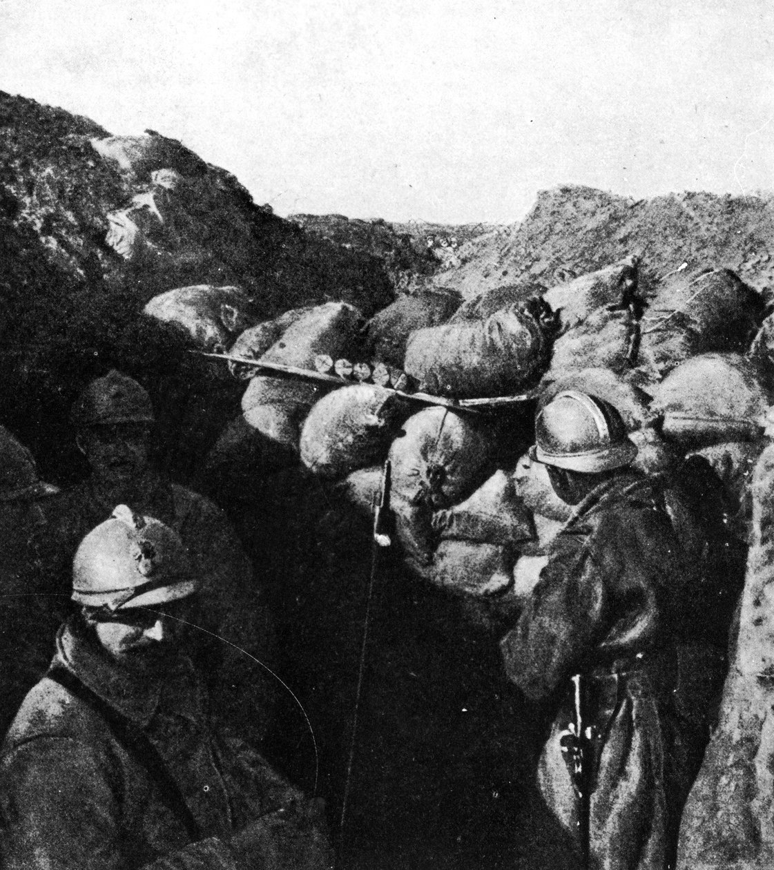 Vihollisia samassa haudassa ensimmäisen maailmansodan aikana, ranskalaiset ja saksalaiset sotilaat erotettuina vain hiekkasäkkiseinämästä (bw kuva) tekijältä French Photographer