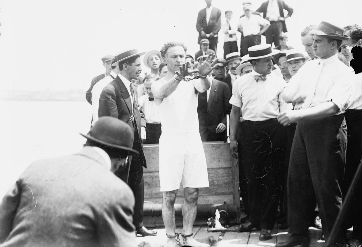 Harry Houdini laitettiin käsiraudoihin ennen kuin hänet naulattiin laatikkoon ja laskettiin New Yorkin lahdelle, 1912 tekijältä George Grantham Bain