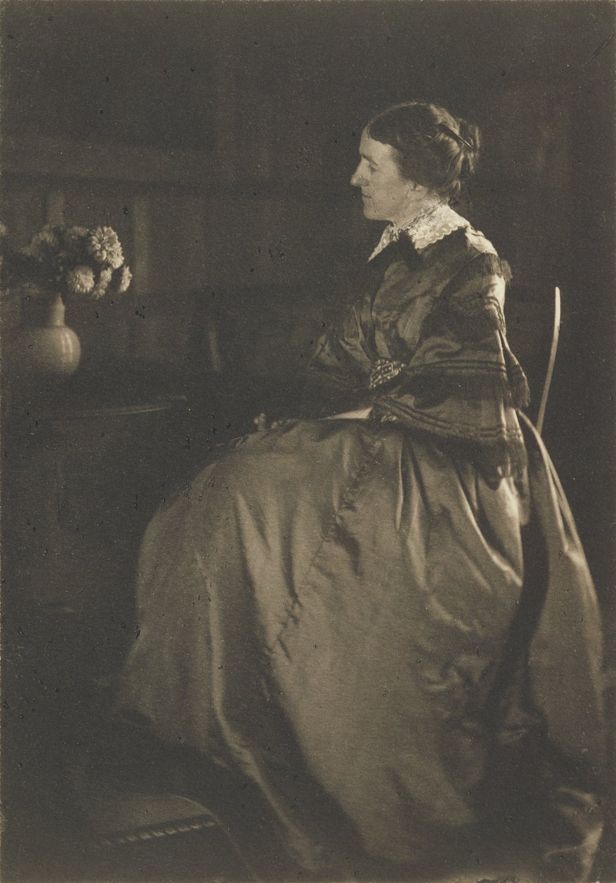[Omakuva pöydän ja kukkien kanssa] tekijältä Gertrude Käsebier