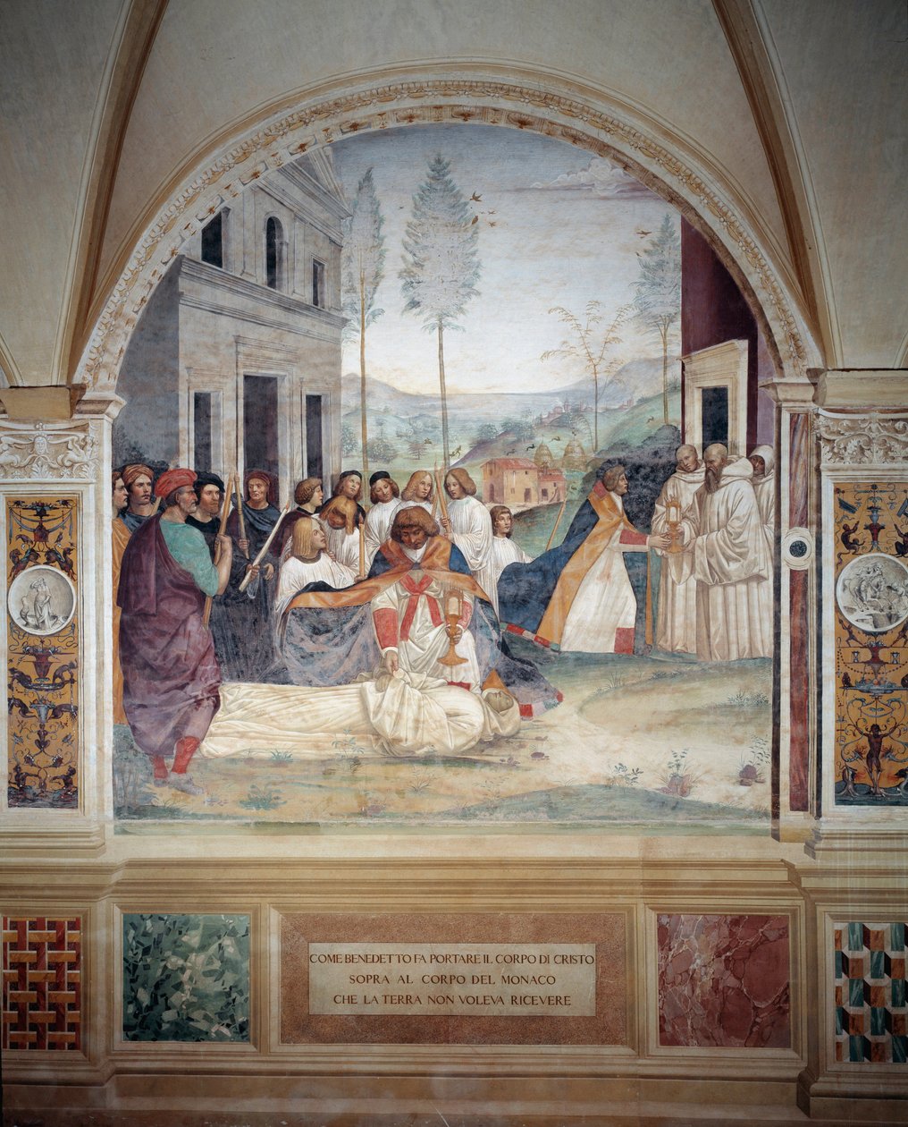 Pyhä Benedictus kantaa Kristuksen ruumista munkin ruumiin päällä, jota maa kieltäytyy hautaamasta Antonio Bazzi dit il Sodoman (1477 - 1549) luomasta freskosta, joka kertoo Pyhän Benedict of Nursielaisen (480 - 567) perustajan elämästä. Benedin ritarikunta tekijältä Giovanni Antonio Bazzi Sodoma