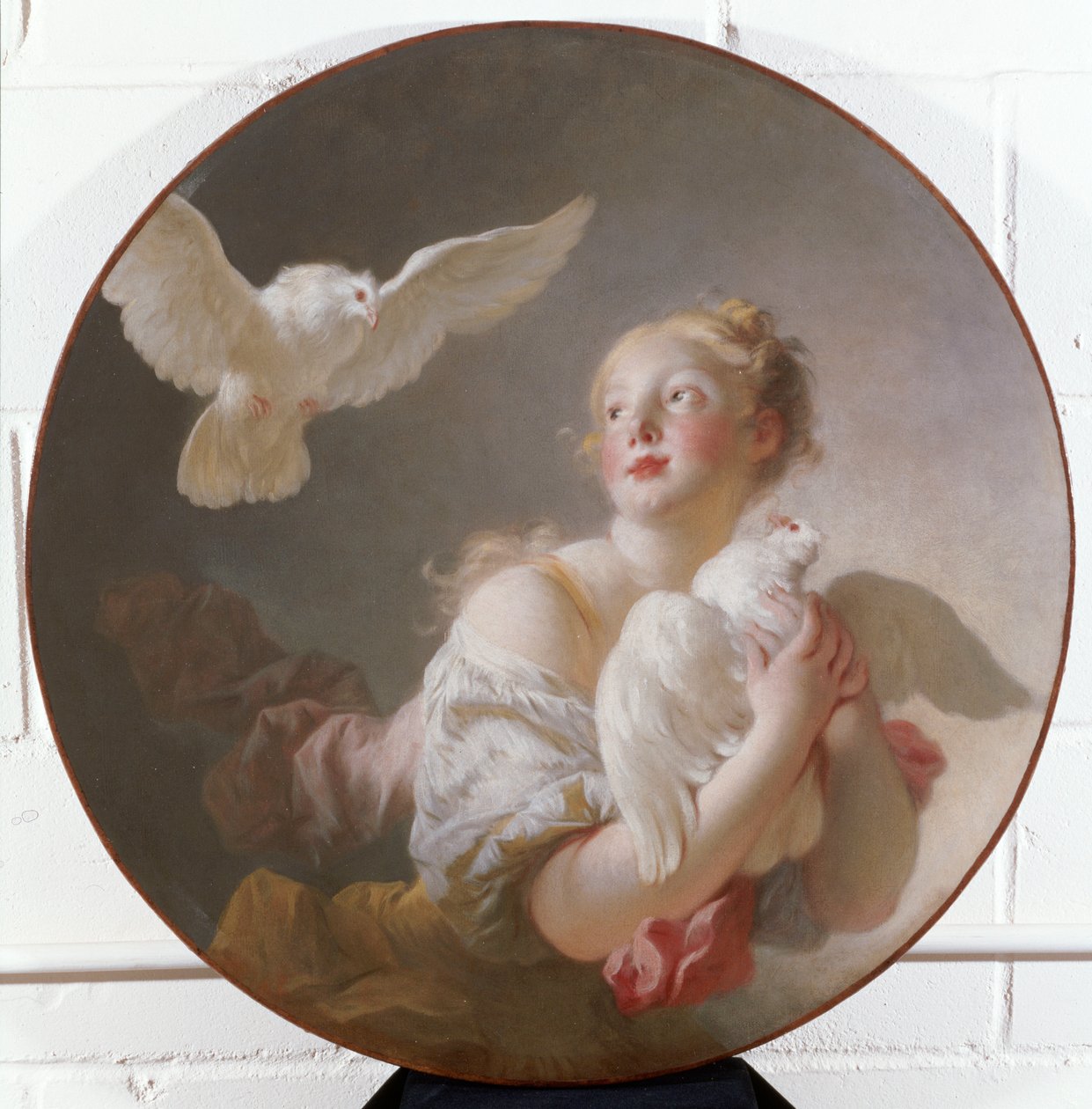Tyttö pitelee kyyhkystä tekijältä Jean Honore Fragonard