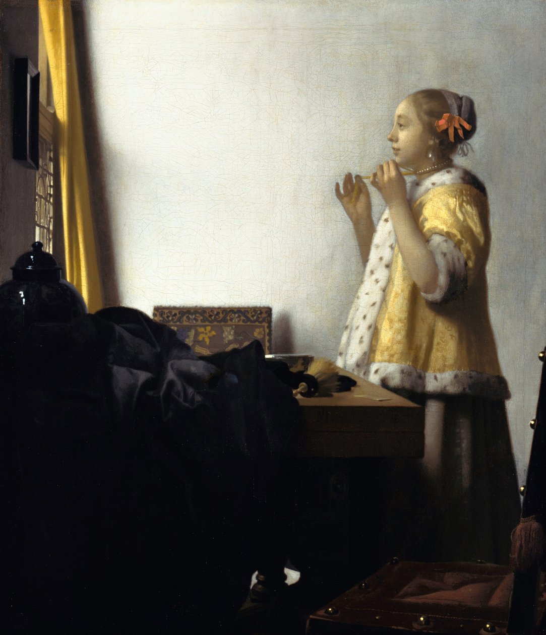 Nuori nainen, jolla on helmikaulakoru tekijältä Johannes Vermeer