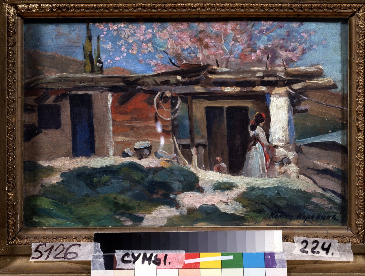 Krim, mantelipuut kukkivat. (Krim, kukkivat mantelipuut). Nuori nainen pienen puutalon edessä, vaaleanpunaisten mantelipuiden alla. Maalaus Konstantin Aleksejevitš Korovin (Konstantin Korovin) (1861-1939), öljy kankaalle tekijältä Konstantin Alekseevich Korovin