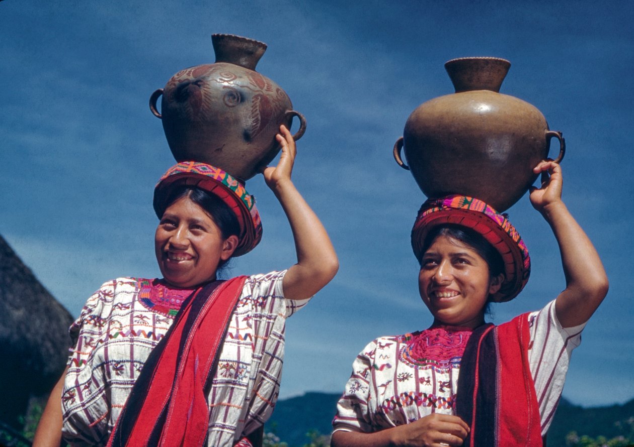 Guatemalalaiset naiset kantavat vesikannuja Nebajin kylässä Guatemalassa. tekijältä Luis Marden