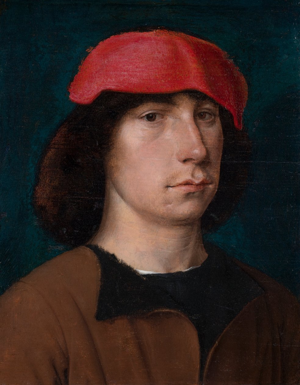 Nuori mies punaisessa lippassa, n. 1512 (öljy tammilevylle) tekijältä Michiel Sittow