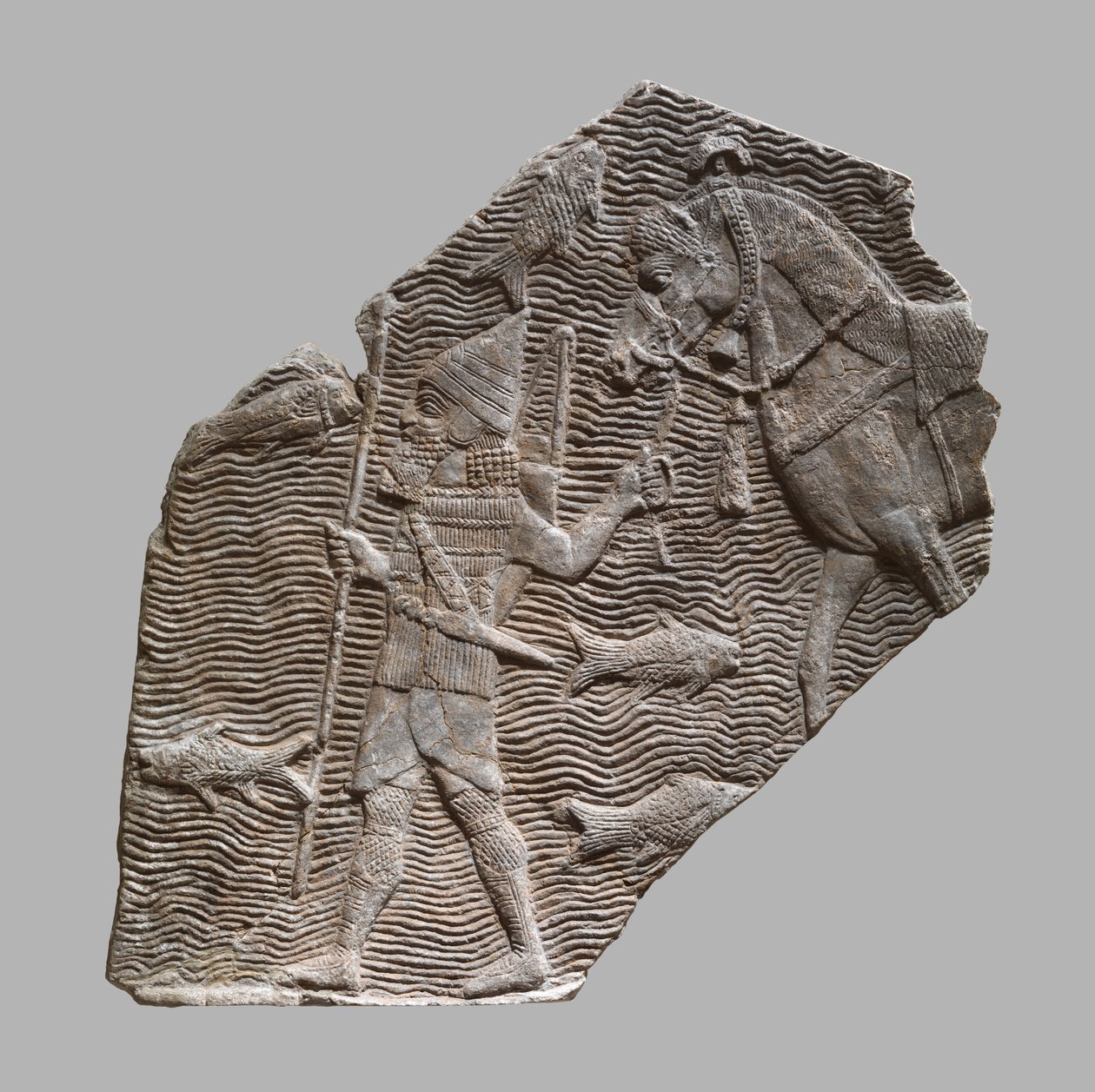 Reliefifragmentti: ratsumies johtaa hevostaan puron varrella, noin 704-681 eaa. (kipsialabasteri). tekijältä Neo Assyrian