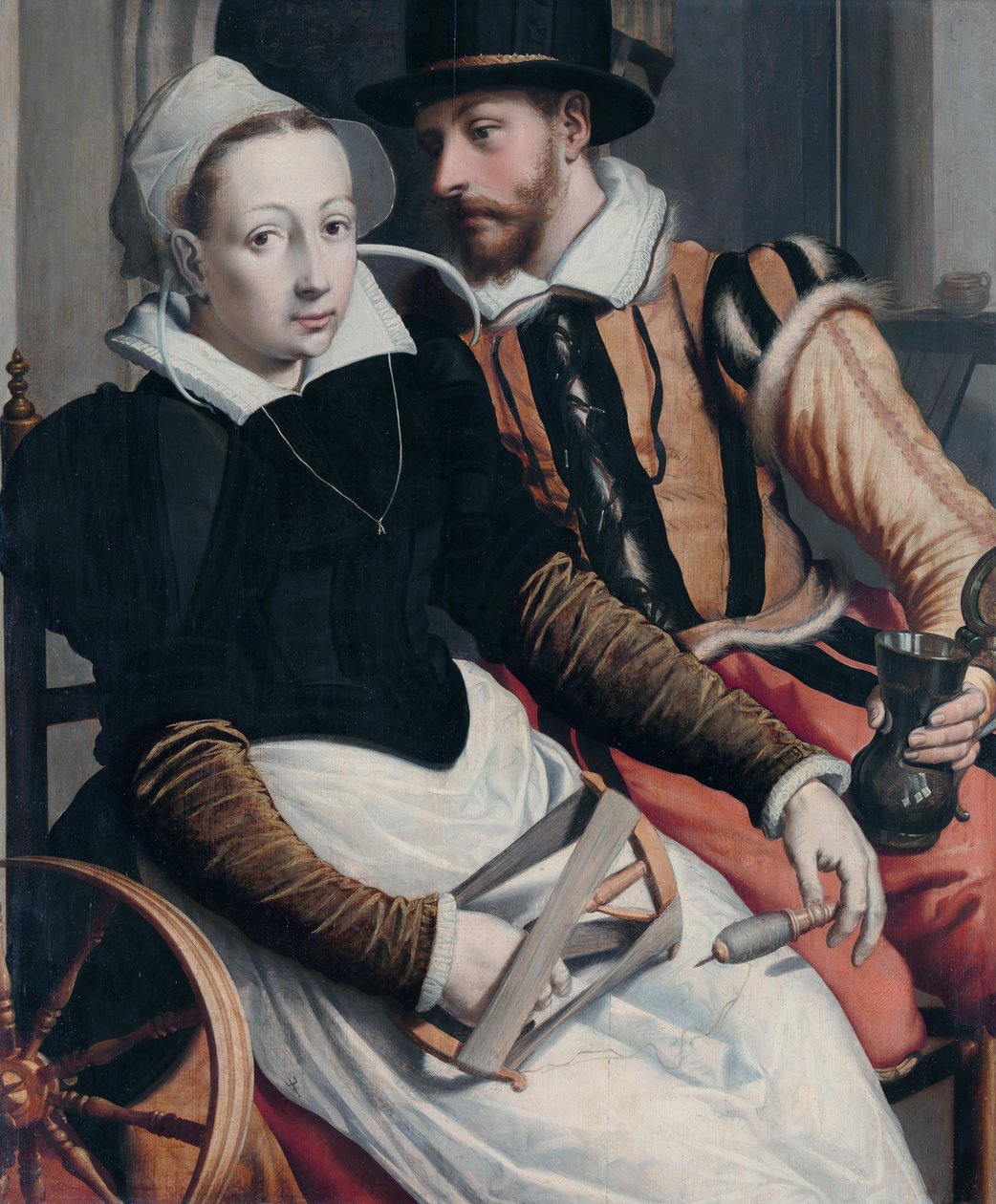 Nainen pyörivässä pyörässä ja mies mukissa istuen sisätiloissa. tekijältä Pieter Pietersz the Elder