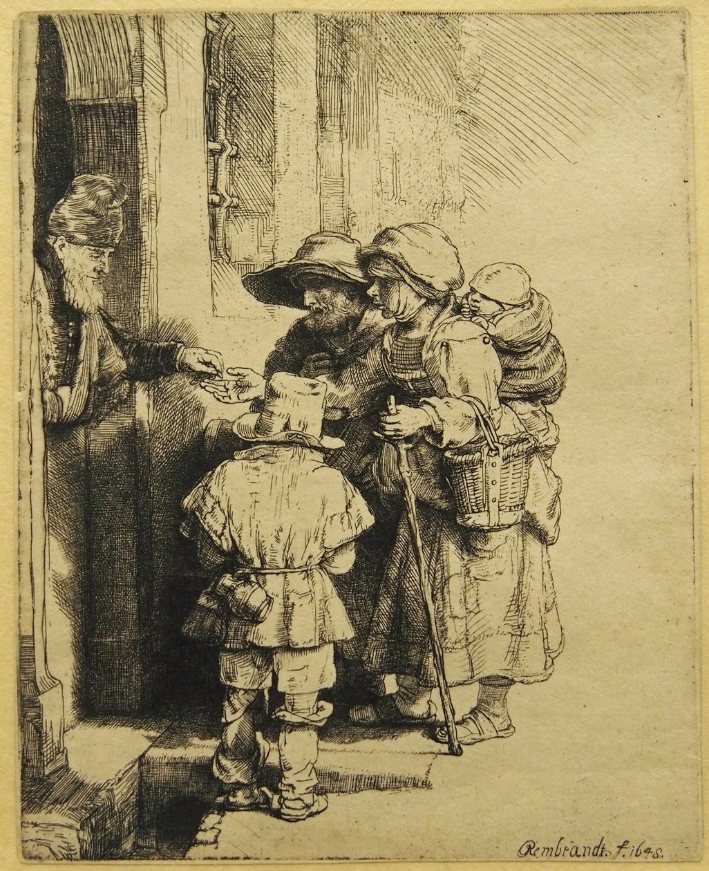 Sokea ja tukeva pelaaja ja perhe vastaanottaa almuja tekijältä Rembrandt van Rijn