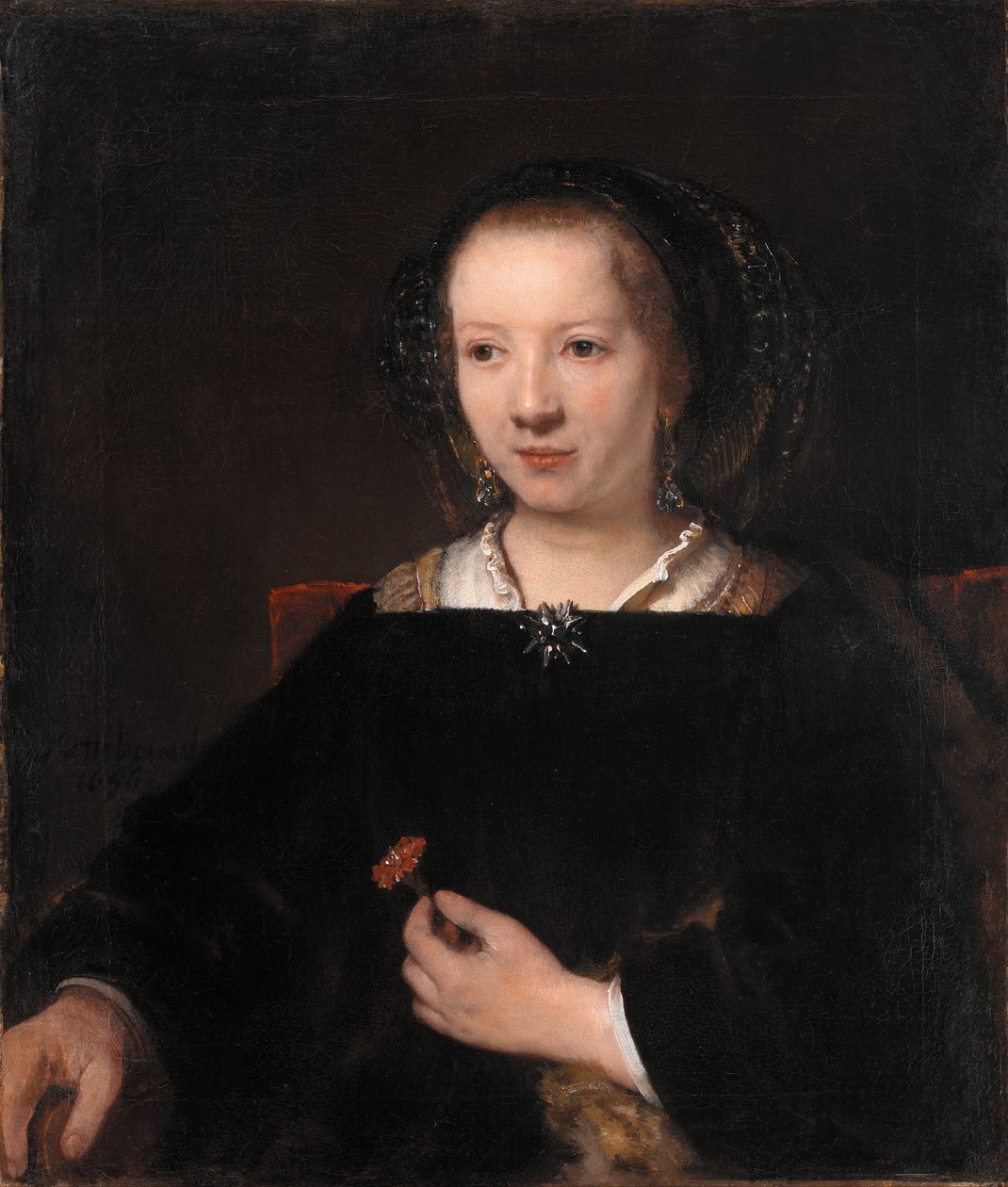 Nuori nainen neilikan kanssa tekijältä Rembrandt van Rijn
