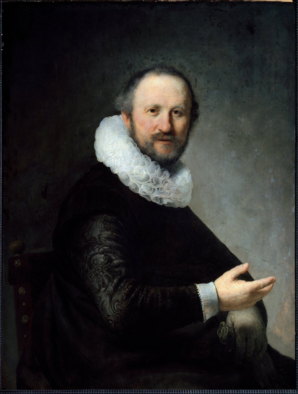 Hollantilainen Bourgeois pitelee käsineitä kädessään röyhelöä. (Maalaus tekijältä Rembrandt van Rijn