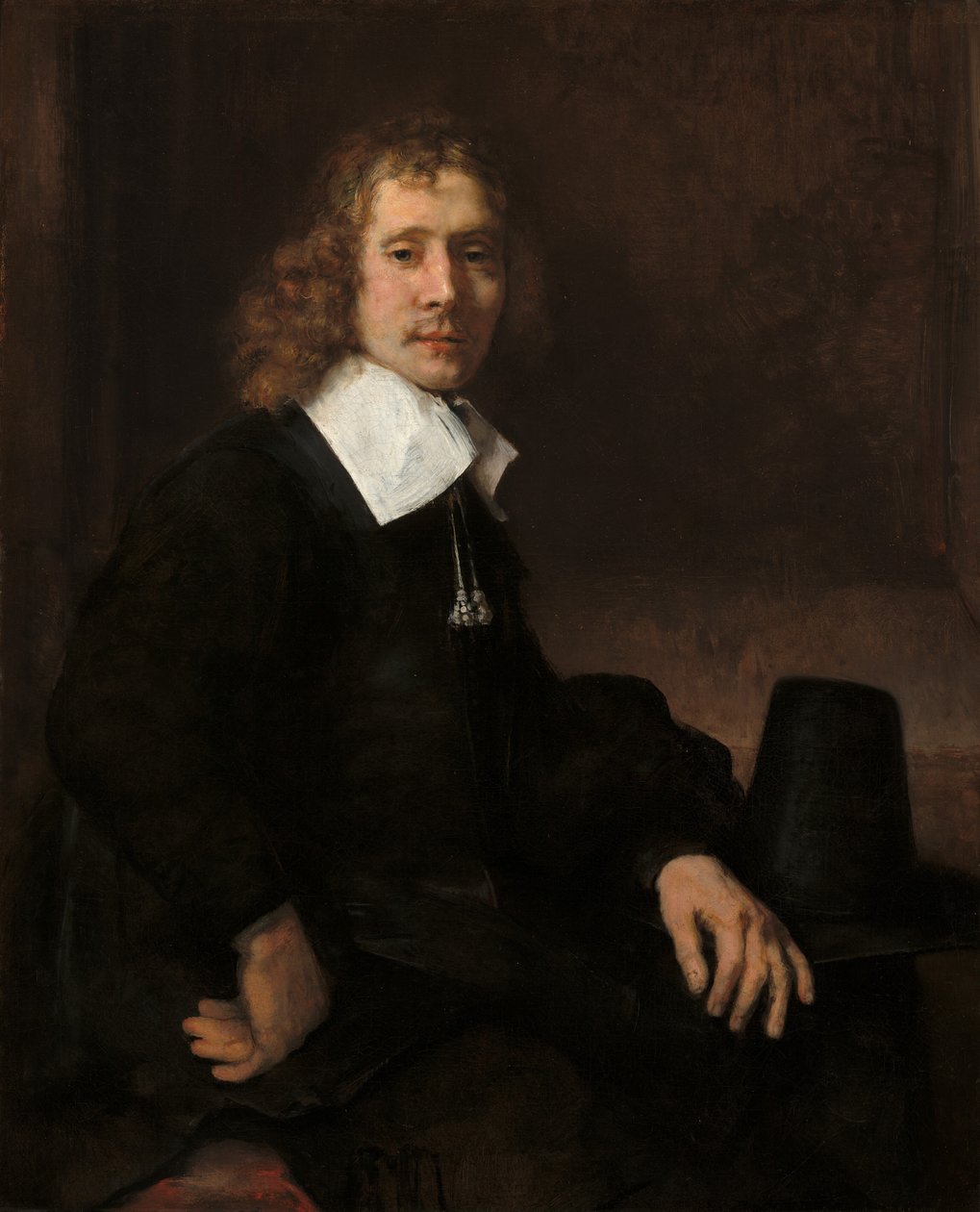 Nuori mies istumassa pöydän ääressä, mahdollisesti Govaert Flinck, c. 1660. tekijältä Rembrandt van Rijn
