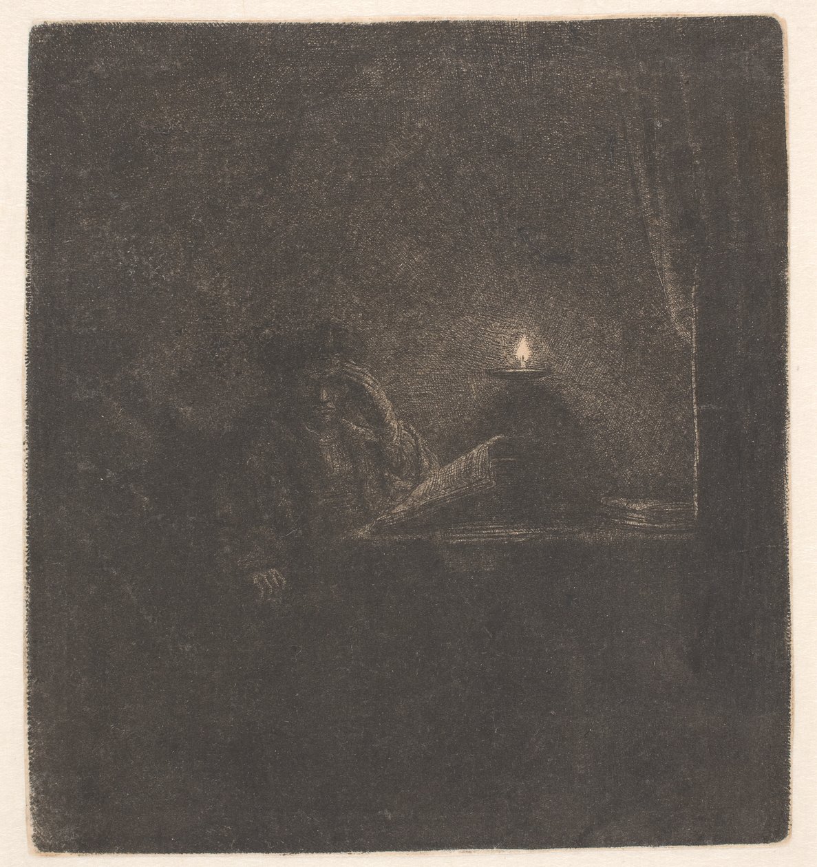 Opiskelija pöydän ääressä kynttilänvalossa tekijältä Rembrandt van Rijn