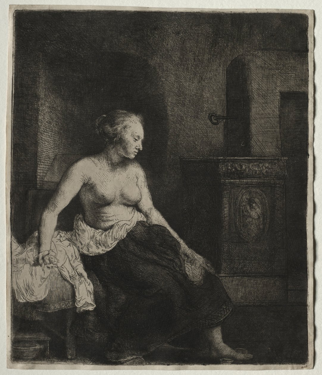 Nainen istumassa puolipukeutuneena lieden vieressä, 1658. tekijältä Rembrandt van Rijn