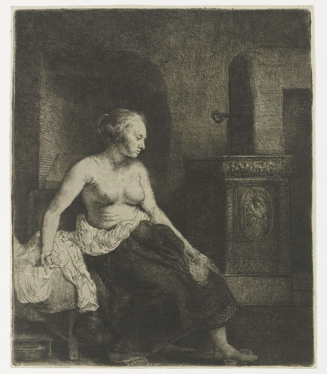 Nainen istuu puolipukeutuneena lieden vieressä tekijältä Rembrandt van Rijn