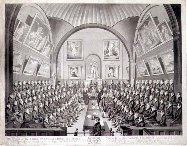 Lord Mayor, Aldermen ja Common Council in the Council Chamber Guildhall, Lontoo, kaiverrus Thomas Sutherland (s. 1785), julkaistu 1825 (litho) tekijältä Richard (after) Dighton