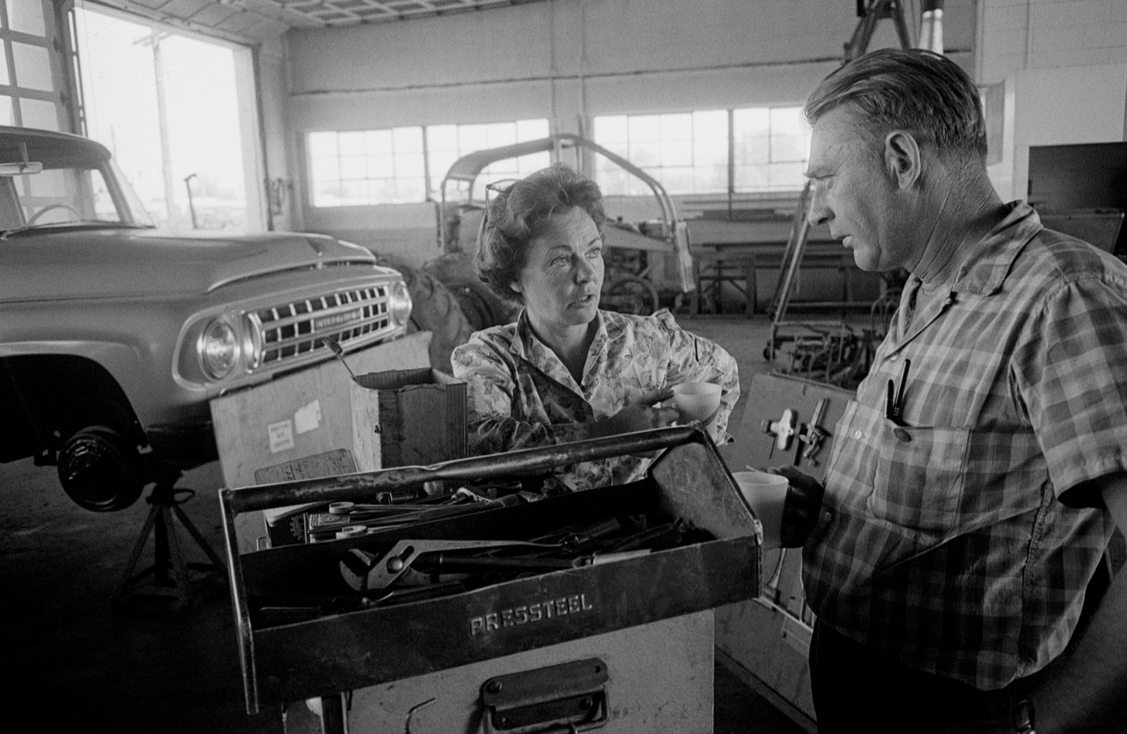 Kuorma-autonkuljettaja Mildred Cooper keskustelee mekaanikon kanssa autotallissa. tekijältä Ted Spiegel