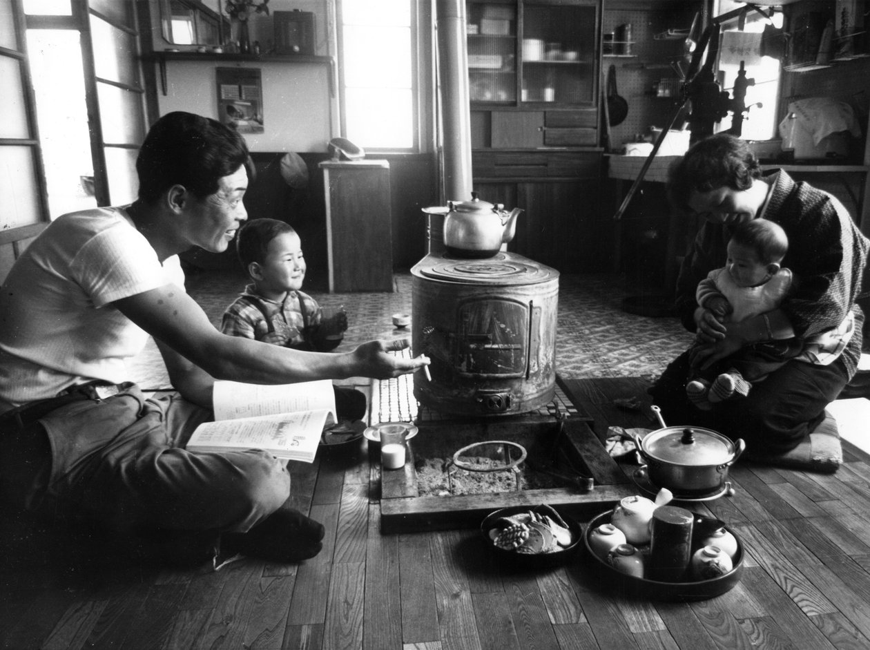 Perhe rentoutumassa olohuoneessaan, Hokkaidon alue, Japani, 1963 tekijältä Unbekannt