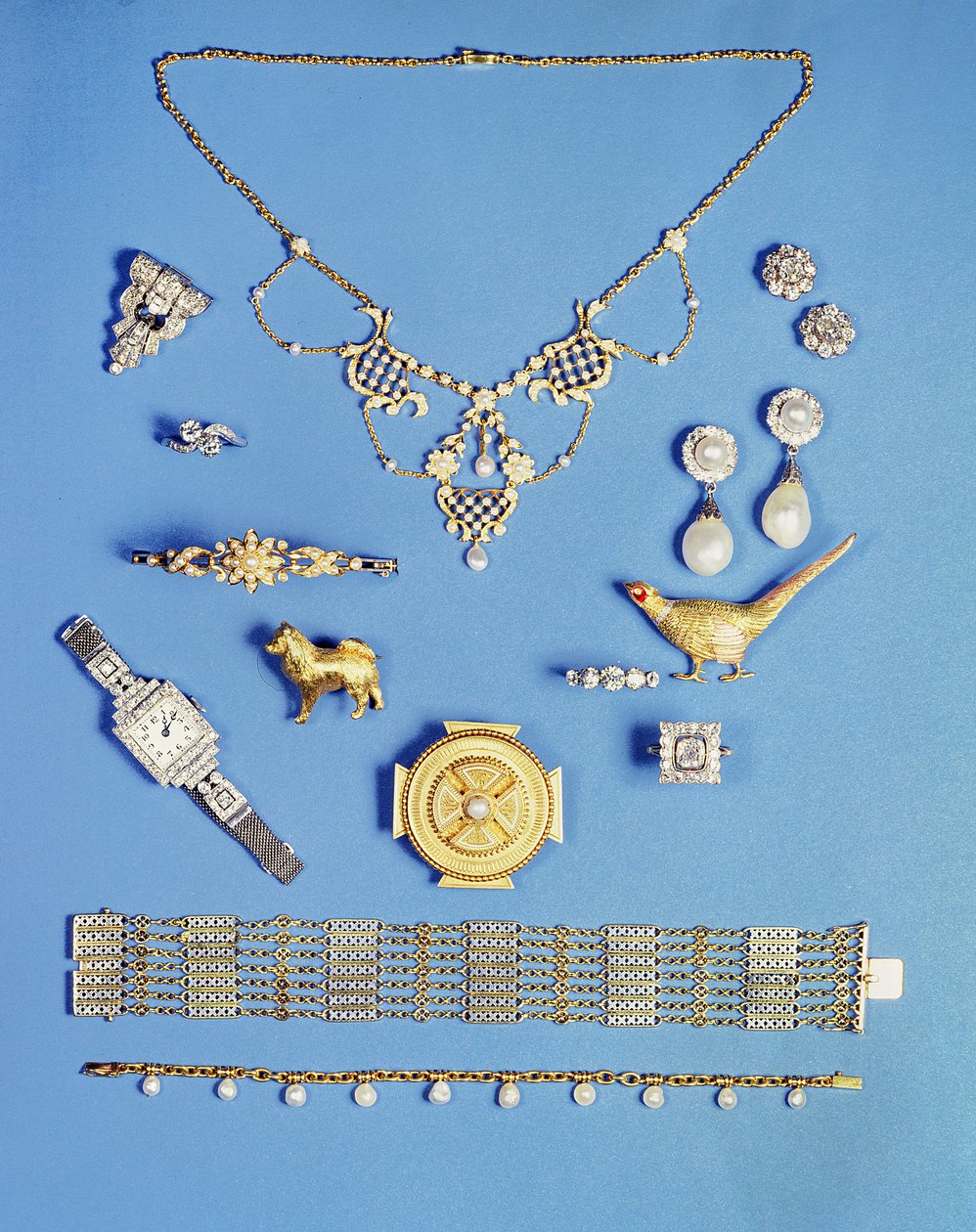 Valikoima koruja: helmi- ja kultariipus; Art Deco timanttiklipsi rintakoru; helmi pudota korvakorut; Kelttiläinen tyyli kultainen rintakoru; Edwardian ketju rannerengas; fasaani rintakoru; puolihelmi kultainen saranoitu rannerengas tekijältä Unbekannt Unbekannt