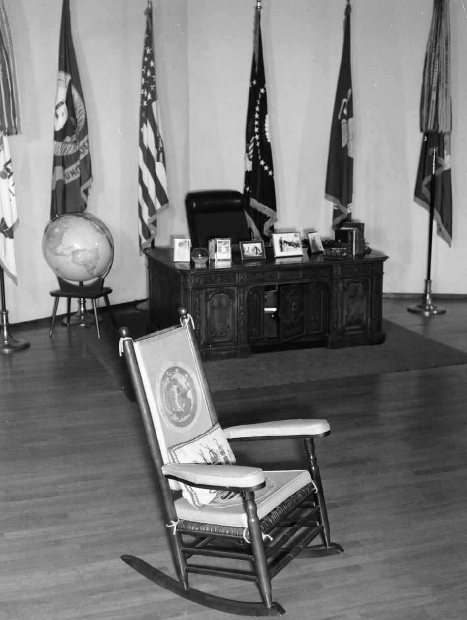 Presidentti John Fitzgerald Kennedyn kuuluisa keinutuoli, hänen työpöytänsä ja muita muistoesineitä esillä. Milano. 1965. tekijältä Unbekannt