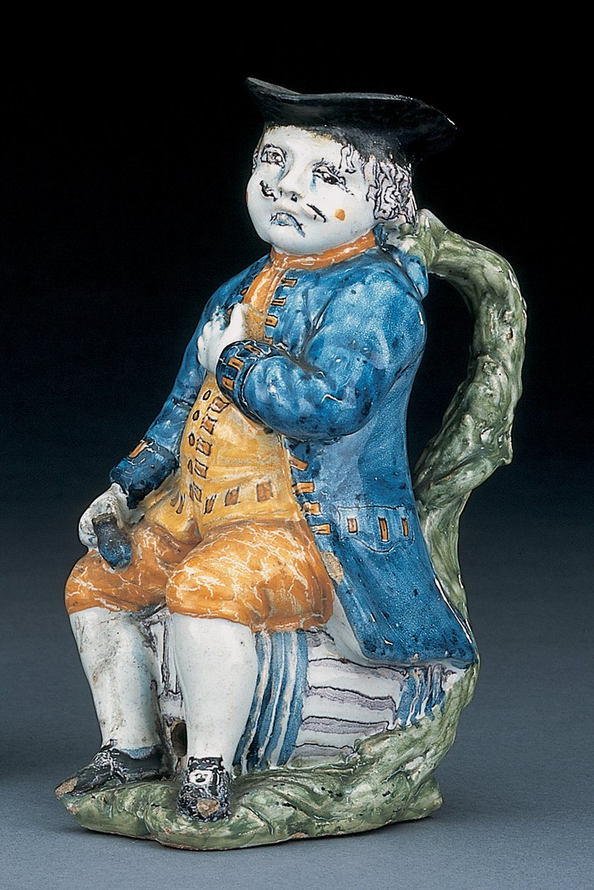 Toby-kannu vaalean mangaanin kasvot ja kädet, pitelee ja tyhjä pallomainen ruskeanvärinen kannu pesty sininen takki ja ratsastushousut ja vihreä liivi, n.1800 tekijältä Unbekannt