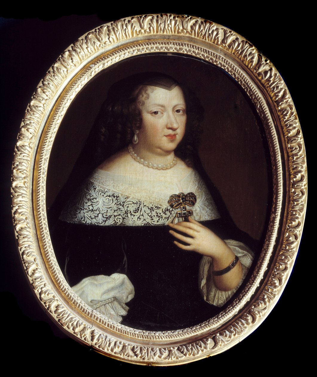 Ranskan kuningattaren Anne Itävallan (1601-1666) muotokuva. Hän käyttää helmiä jalokiviä, jalokivellä koristeltua ristinmuotoista riipusta ja rannekorua vasemman ranteen ympärillä. Anonyymi maalaus tekijältä Unknown artist