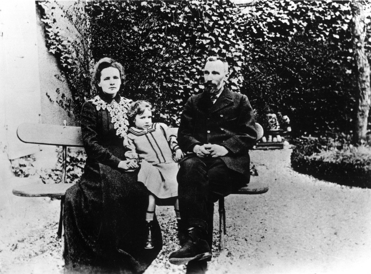 Pierre (1859-1906) ja Marie Curie (1867-1934) istuvat penkillä puutarhassa. tekijältä Unknown photographer