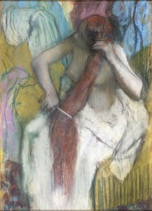 Nainen kampaa hiuksiaan tekijältä Edgar Degas