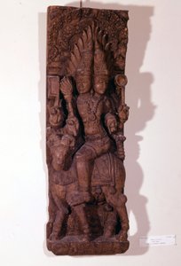 Agni, tulen jumala, kuvattu kahdella päällä (hauispää) pässissä hindujen mytologian mukaan. Puuveistos 1600-luvulta. Pariisi, Musée Guimet. tekijältä Indian School