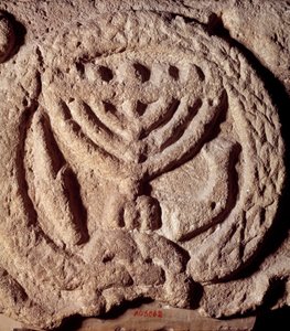 Juutalaisuus: arkkitehtoninen elementti synagogan basaltissa, jota koristaa kynttilänjalka, jossa on seitsemän haaraa (Menora tai Menorah), palmu ja trumpetti. Transjordanista. Noin 100 jKr. Pariisi, Louvre-museo tekijältä Jewish School