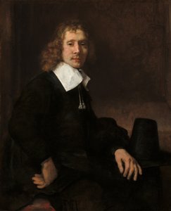 Nuori mies istumassa pöydän ääressä, mahdollisesti Govaert Flinck, c. 1660. tekijältä Rembrandt van Rijn