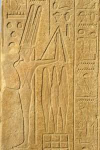 Muinainen Egypti, seinämaalaus/kaiverrus, Min-jumala, Karnakin temppeli, Luxor, hedelmällisyyden jumala, pitelee ruoskaa (kuva) tekijältä School Egyptian