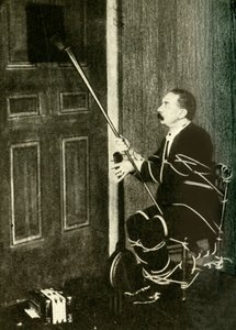 John Nevil Maskelyne esittää henkikaapin illuusion, v. 1910. tekijältä Unbekannt