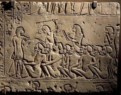 Joukko negroideja vankeja nuijilla aseistautuneiden vartijoiden ympäröimänä, kun kirjuri laatii raporttia, reliefi Horemhebin haudasta Saqqarassa. tekijältä Egyptian 18th Dynasty