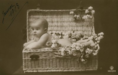 Postikortti vauvasta pajukorissa kukkien kanssa, lähetetty tammikuussa 1913 tekijältä French Photographer