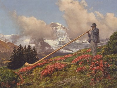 Sveitsi: Alphorn Blower, Jungfrau taustalla (värikuva) tekijältä Jean Gaberell