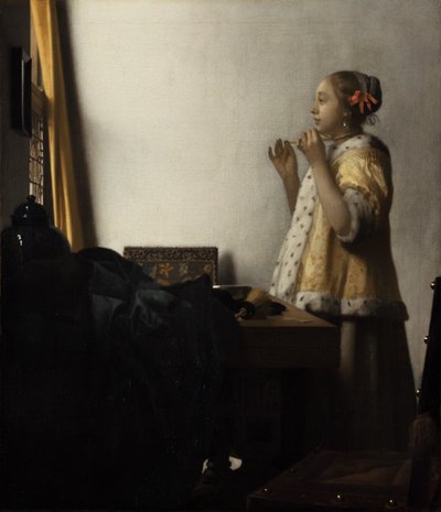 Nuori nainen, jolla on helmikaulakoru tekijältä Johannes Vermeer
