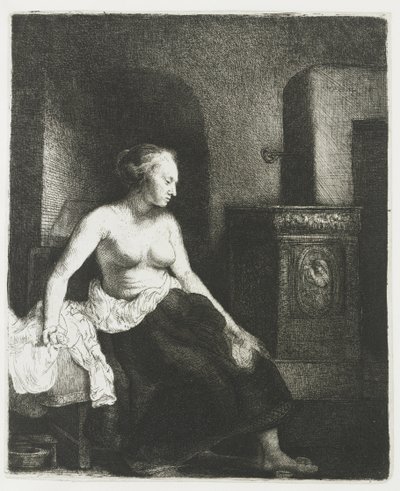 Nainen istuu puolipukeutuneena lieden vieressä tekijältä Rembrandt van Rijn