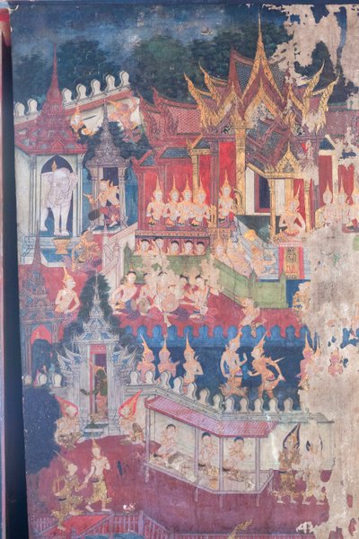 Buddhaisawan-kappelin seinämaalaukset, joissa Buddha esiintyy kuninkaallisessa asussa nöyryyttääkseen ja vakuuttaakseen ylpeän mutta harhaanjohdetun keisari Jambupatin siitä, että tie valaistumiseen on parempi kuin pelkkä aineellinen rikkaus, Wang Na:n pal tekijältä School Thai