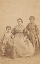 Carte-de-visite of a young woman and two children, 1864 - 1866.    1185411   fi       finnish Successfully Translated  Original: The Frailty of Human Happiness. A Man pursued by a Dragon clings to a Tree, licking Honey from his fingers Translat: The Frailt