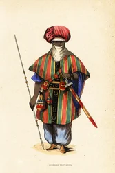 Jalo tuareg-soturi Agadezista, Nigeristä, tagelmustissa (turbaani ja verho), taktkatissa (paita) ja akarbeyssä (housut)